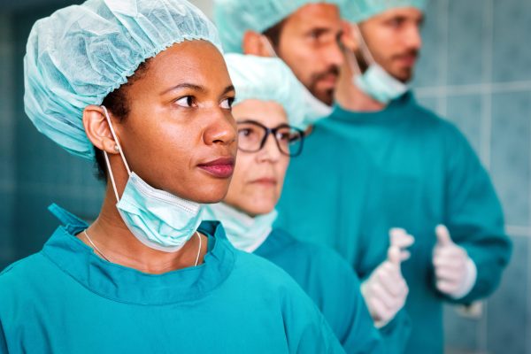 Portrait of a successful medical surgeon team inside operating room, ready to work in hospital